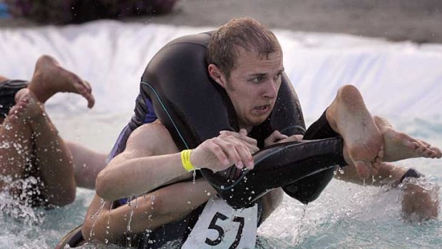 Entrants compete in Finland's annual wife carrying world championships.