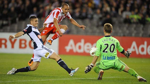 Rafik Djebbour (middle), of Olympiakos, shoots at goal against Melbourne Victory in its May friendly. Victory is now suing the promoter of the match.