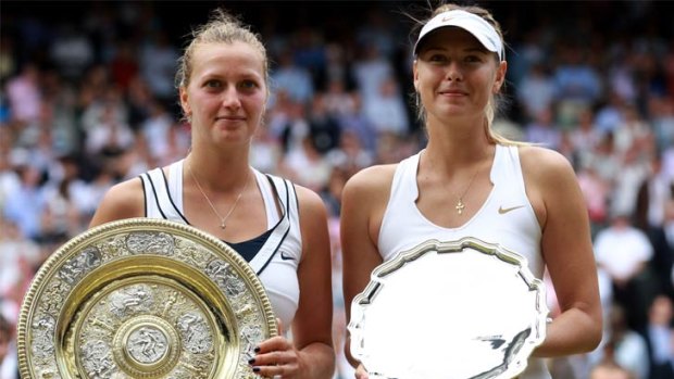 Petra Kvitova of the Czech Republic (L) and Maria Sharapova of Russia hold up their trophies.