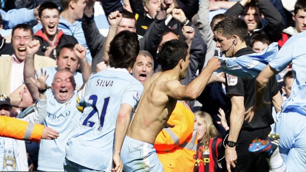 Title won ... Sergio Aguero of Manchester City celebrates after scoring the championship winning goal in the fifth minute of injury against Queens Park Rangers.