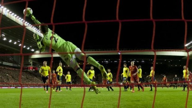 Sunderland's goalkeeper Vito Mannone dives in vain to save a free kick from Liverpool's Steven Gerrard.