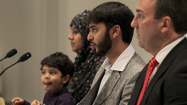 'Coming back to Australia represents a very important step for me and for my family': Dr Haneef addresses the media with his wife Firdous and three-year-old daughter Haniyah in Brisbane.