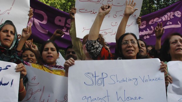 Pakistani women shout their protests at the public whipping of a girl by members of the Taliban, captured on video 