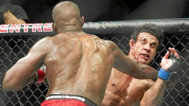 Jon Jones, left, punches Vitor Belfort during the light heavyweight championship title bout at UFC 152 in Toronto.