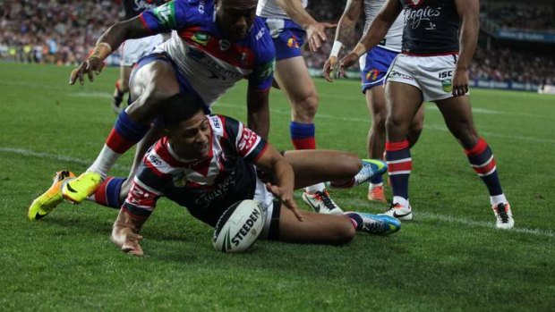 High-flier: Daniel Tupou touches down for the Roosters.