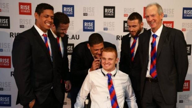 Alex McKinnon surrounded by Knights teammates (from left) Dane Gagai, Korbin Sims, Willie Mason, Darius Boyd, and coach Wayne Bennett.