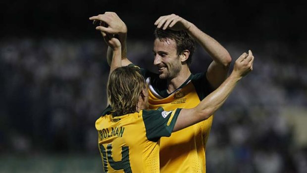 Australia's Josh Kennedy (R) and Brett Holman celebrate a goal against Saudi Arabia.