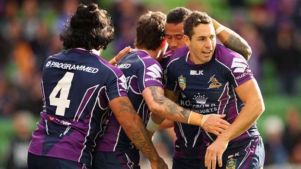 The Storm's Billy Slater celebrates with teammates after crossing for a try against Parramatta.