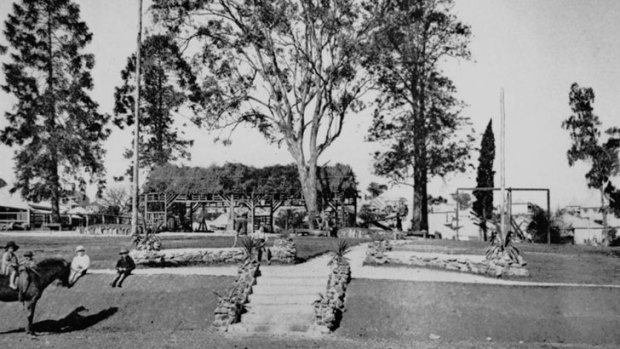 This photo from the Queensland State Library archives shows a set of steps, decorated with stone edgings, leading to the playground bordered by stone walls