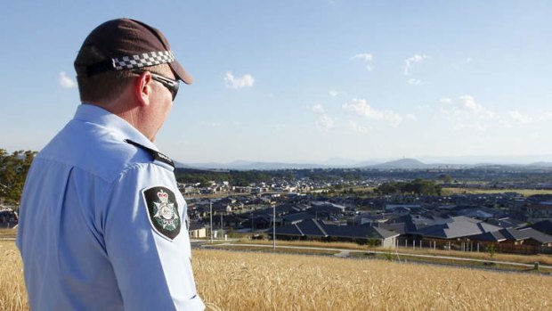 Sergeant Andrew Mitchell looks out over the sprawling expanse of residential construction in Gungahlin.