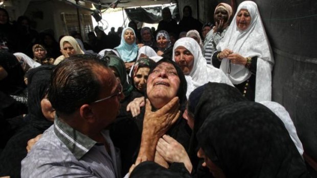 The mother of Mohammed Dudin weeps during his funeral. 