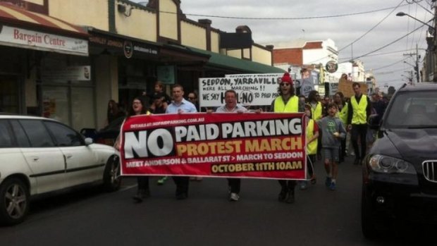 Protesters at Yarraville Village march against a proposal to introduce paid parking.