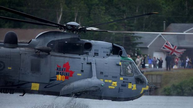 Prince William 'waterbirds' along a small lake in a Canadian Forces Sea King helicopter.
