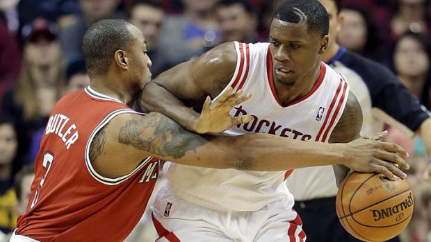 Caron Butler of the Milwaukee Bucks tries to steal the ball from Terrence Jones of the Houston Rockets.