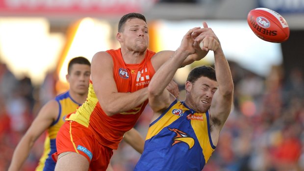 The Suns' Steven May challenges West Coast's Jeremy McGovern.
