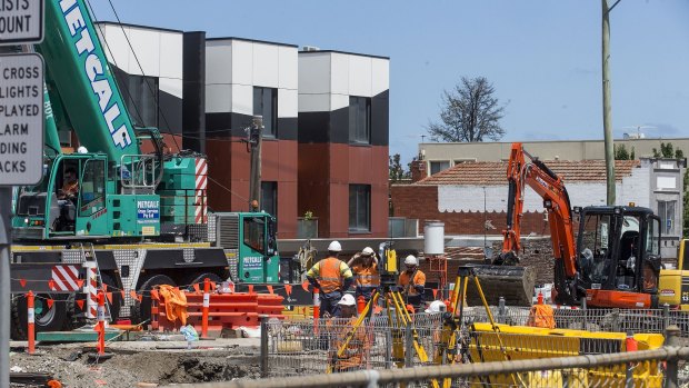 Workers remove the North Road level crossing near Ormond railway station early this year.