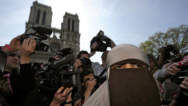 Kenza Drider, a French Muslim of North African descent, wears a niqab outside the Notre Dame Cathedral in Paris.