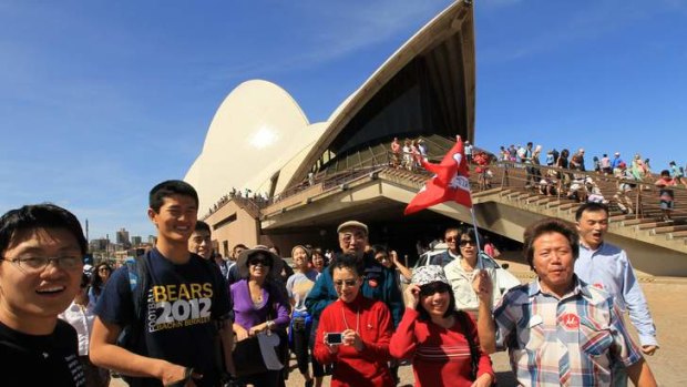 A group of Chinese tourists at the Sydney Opera House.