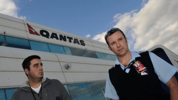 Qantas worker Anothny Surace (left) with Australian Workers' Union representative and Qantas employee Marshall Arkcoll at Tullamarine yesterday.