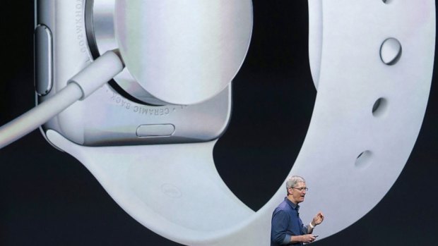 Apple CEO Tim Cook unveils the Apple Watch on stage.