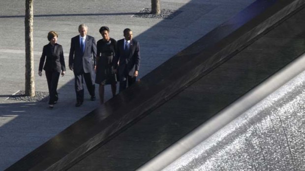 Laura and George Bush accompany their successors, Michelle and Barack Obama, next to the reflective pools at the World Trade Centre site.