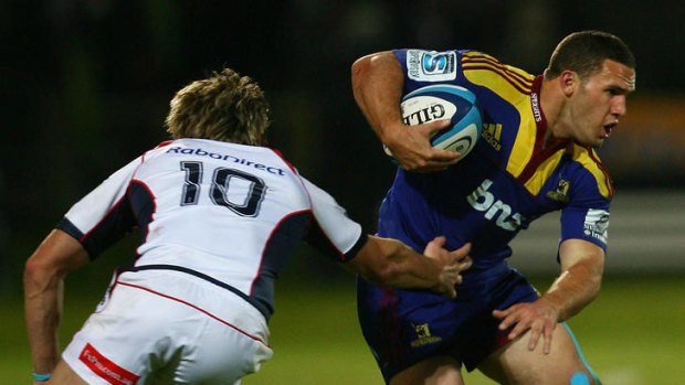 Shaun Treeby of the Highlanders makes a break past James O'Connor.