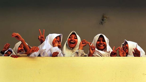 Students laugh during a break in classes at al-Mukmin school.