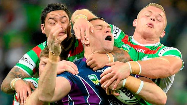 Impact: Jason Ryles of the Storm is tackled by the Souths defence in the 26-8 win last night.