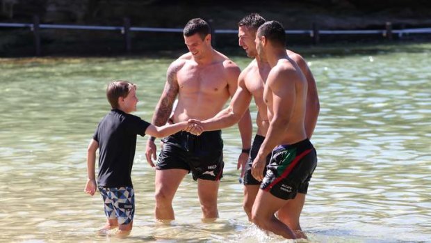 Beach boys: 12-year-old Felix Best meets his heroes, Luke and Sam Burgess and Ben Teo, at Clovelly yesterday.