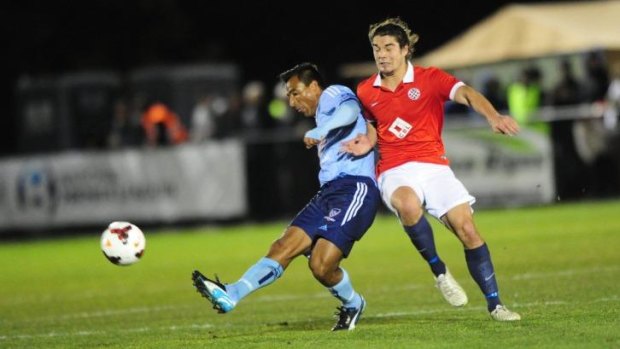 Sydney FC star Nick Carle gets away from Canberra FC's Callum Smith.