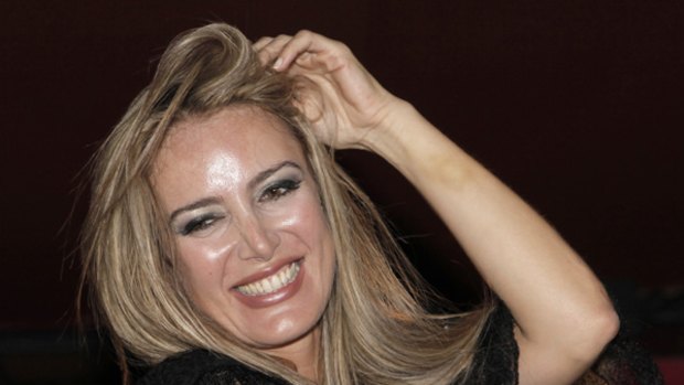 In this Saturday, August 1, 2009 file photo, Italian escort Patrizia D'Addario smiles during an Italian style party named "I love Silvio", in Paris.
