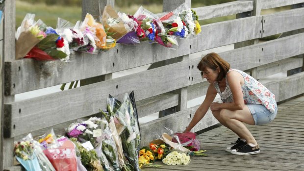 A woman lays flowers near where the plane crashed.