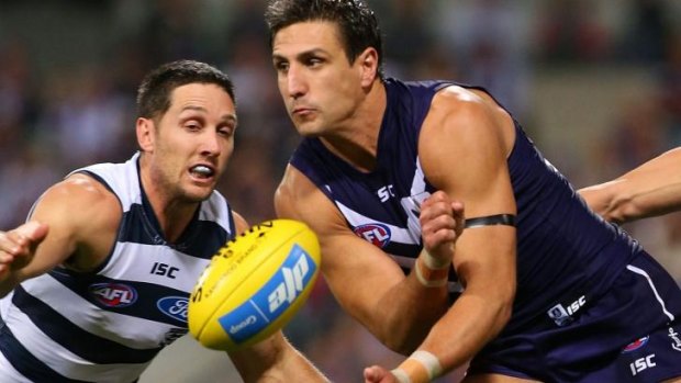 Docker Matthew Pavlich (right) and Geelong's Harry Taylor.