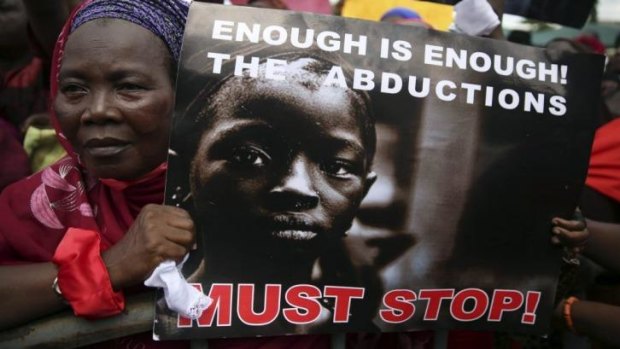 A woman holds a sign during a protest demanding the release of abducted secondary school girls from the remote village of Chibok, in Lagos May 5, 2014. 