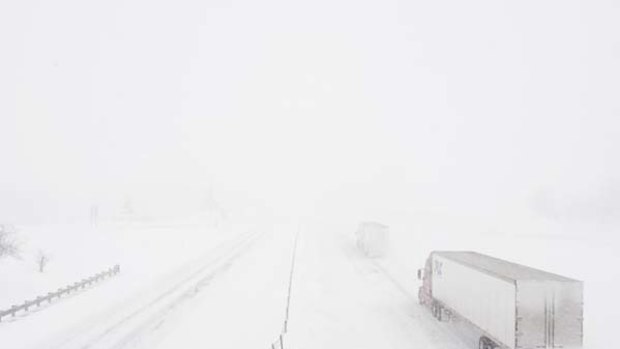 Trucks disappear into the snow near Boonville, Missouri.