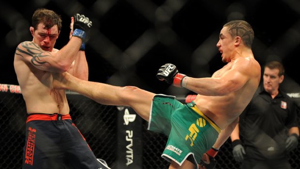 Best foot forward .. Robert Whittaker lands a kick on Brad Scott during his TUF: The Smashes victory in December.