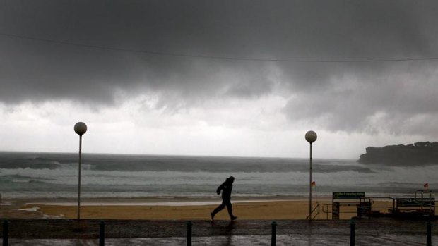 The big wet ... Bondi lifeguards run back to their tower in a rain storm.