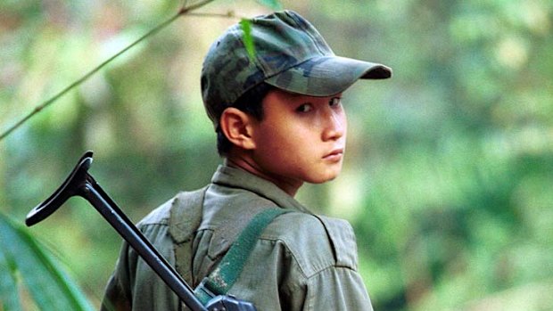 On guard ...  a Karen fighter at his jungle camp.