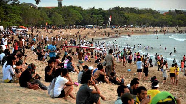 Tourists watch the sunset from Kuta beach. Bali tourism has bounced back from the deadly bombings 10 years ago.