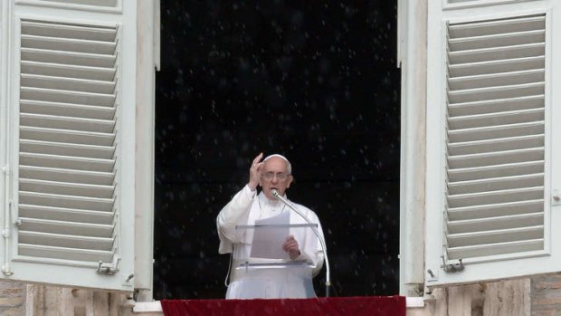 Pope Francis blesses faithfuls gathered in St.Peter's Square at the Vatican following his Sunday Angelus prayer on June 9, 2013.