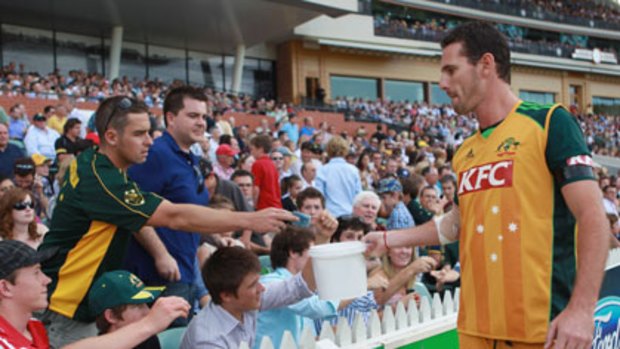 All for a good cause ... Australia's Twenty20 players, including Shaun Tait, collected money from fans at Adelaide Oval for Queensland's flood victims during last night's match against England.
