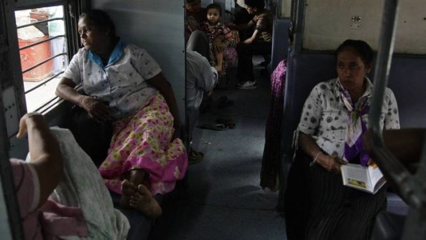Passengers sit in a train as they wait for electricity to be restored.