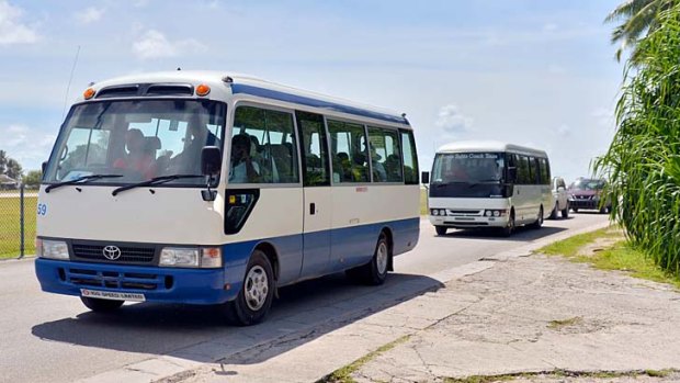 Asylum seekers are taken on a tour of Nauru.