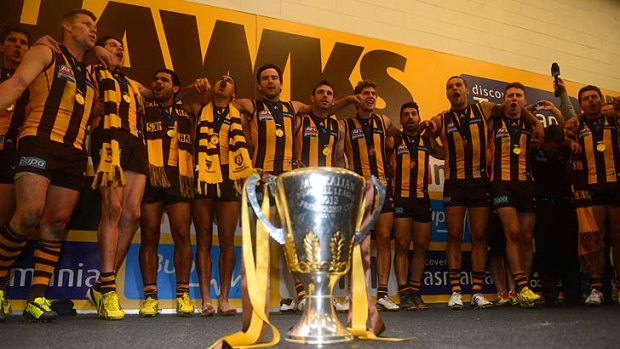Job half done: The Hawks celebrate their 2013 premiership, but believe they owe themselves another in 2014.