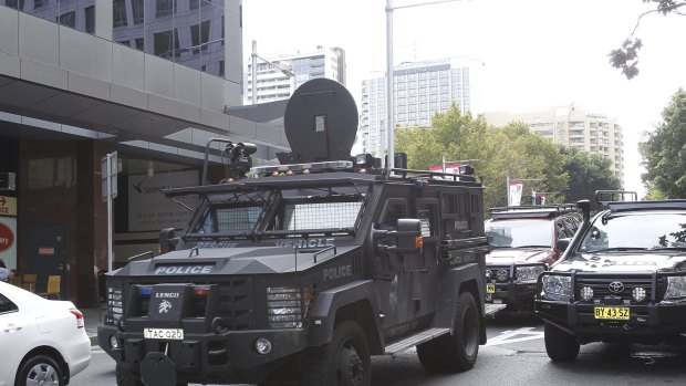 A NSW police tactical vechile drives past the Downing Centre courts on Liverpool street this morning.