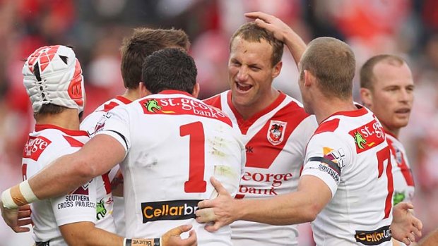 Mark Gasnier is congratulated by teammates after a Dragons try.