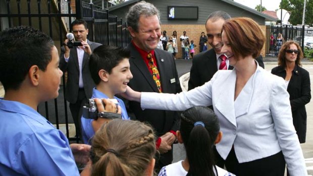 Warning of more ''nuts and bolts'' work to be done &#8230; Julia Gillard with pupils at Our Lady of the Rosary Primary, St Marys.