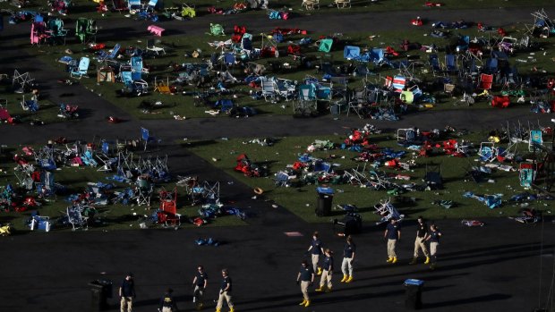 Investigators comb festival grounds across the street from the Mandalay Bay Resort and Casino after  Stephen Paddock opened fire on concertgoers, killing 58 and injuring almost 500.
