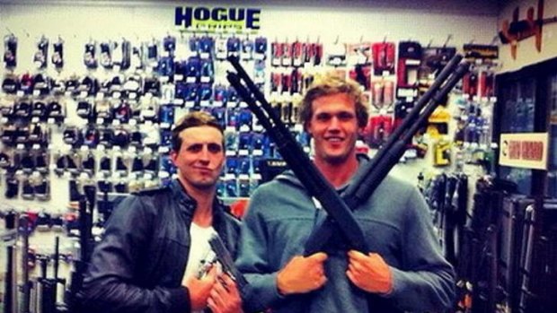 Under fire: Nick D'Arcy (left) and Kenrick Monk pose with the guns.