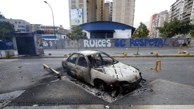 View of a car burnt during an opposition protest against the government of President Nicolas Maduro, in Caracas.